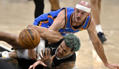 San Antonio Spurs forward Jeremy Sochan, bottom, and Oklahoma City Thunder guard Alex Caruso fight for possession during the first half of an NBA basketball game, Sunday, March 2, 2025, in San Antonio. (AP Photo/Darren Abate)