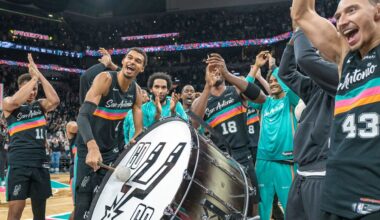 San Antonio Spurs forward Victor Wembanyama (1) hits on a drum as he and teammates celebrate with the Spurs fans after defeating the Oklahoma Thunder in an NBA basketball game in San Antonio, Tuesday, Dec. 23, 2025. (AP Photo/Rodolfo Gonzalez)