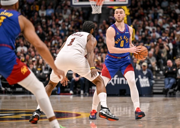 DENVER , CO - FEBRUARY 9: Christian Braun (0) of the Denver Nuggets looks for Bruce Brown (11) as James Harden (1) of the Cleveland Cavaliers defends during the fourth quarter of the Cavs' 119-117 win at Ball Arena in Denver on Monday, February 9, 2026. (Photo by AAron Ontiveroz/The Denver Post)