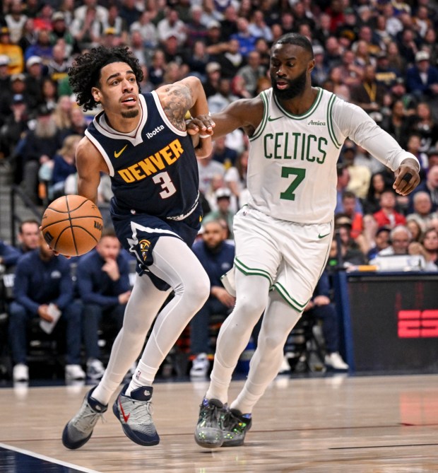 Julian Strawther (3) of the Nuggets passes as Jaylen Brown (7) of the Boston Celtics defends during the second quarter at Ball Arena in Denver on Wednesday, February 25, 2026. (Photo by AAron Ontiveroz/The Denver Post)