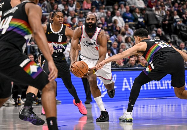 James Harden (1) of the LA Clippers draws a foul from Spencer Jones (21) of the Denver Nuggets as Peyton Watson (8) defends during the first quarter at Ball arena in Denver, Colorado on Friday, January 30, 2026. (Photo by AAron Ontiveroz/The Denver Post)