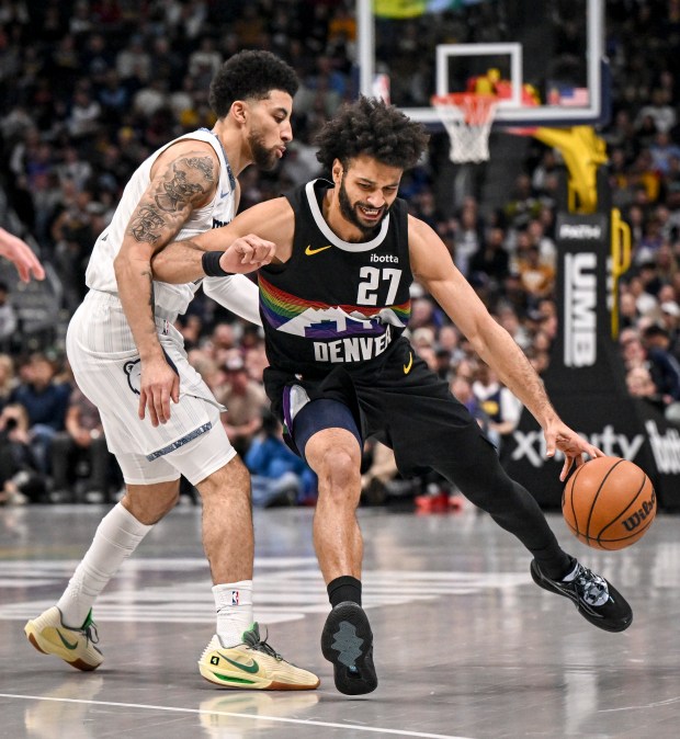 Jamal Murray (27) of the Denver Nuggets draws a foul from Scotty Pippen Jr. (1) of the Memphis Grizzlies during the second quarter at Ball Arena in Denver, Colorado on Wednesday, Feb. 11, 2026. (Photo by AAron Ontiveroz/The Denver Post)