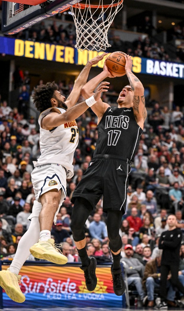 Michael Porter Jr. (17) of the Brooklyn Nets finishes a fast break over Jamal Murray (27) of the Denver Nuggets during the fourth quarter of the Nuggets' 107-103 win at Ball Arena in Denver on Thursday. (Photo by AAron Ontiveroz/The Denver Post)