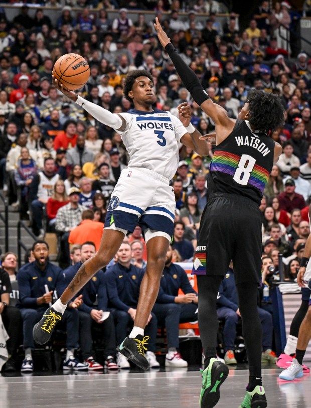 Jaden McDaniels (3) of the Minnesota Timberwolves passes over Peyton Watson (8) of the Denver Nuggets during the second quarter at Ball Arena in Denver, Colorado on Thursday, December 25, 2025. (Photo by AAron Ontiveroz/The Denver Post)