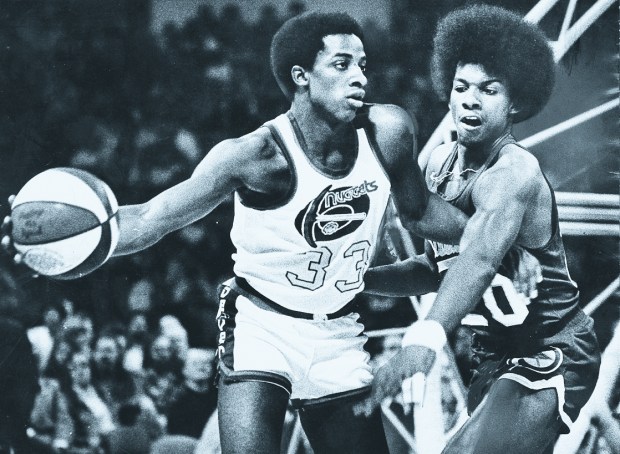 Nuggets rookie David Thompson keeps the Indiana Pacers' Darnell Hillman away from the ball during a game at McNichols Sports Arena in December 1975. The Nuggets went 60-24 in the ABA's last season. (Photo by John Sunderland/The Denver Post)