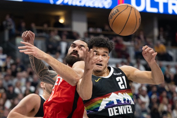 Denver Nuggets forward Spencer Jones (21) comes down with a defensive rebound in front of Houston Rockets center Steven Adams (12)  on Saturday, Dec. 20, 2025, at Ball Arena in Denver. (Photo by Timothy Hurst/The Denver Post)