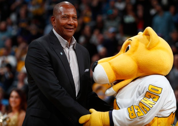 Retired Denver Nuggets forward Alex English, left, is welcomed to the court by team mascot Rocky the mountain lion during the team's 50th anniversary celebration before the second half of an NBA basketball game Saturday, Oct. 21, 2017, in Denver. (AP Photo/David Zalubowski)