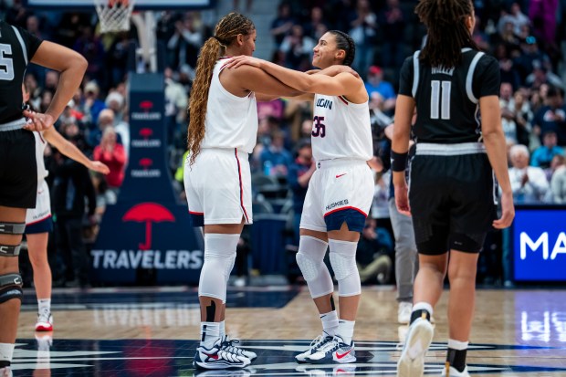 Sarah Strong #21 and Azzi Fudd #35 of the Connecticut Huskies speak before their NCAA women's basketball game against the Georgetown Hoyas at PeoplesBank Arena on February 26, 2026 in Hartford. (Joe Buglewicz/Getty Images)