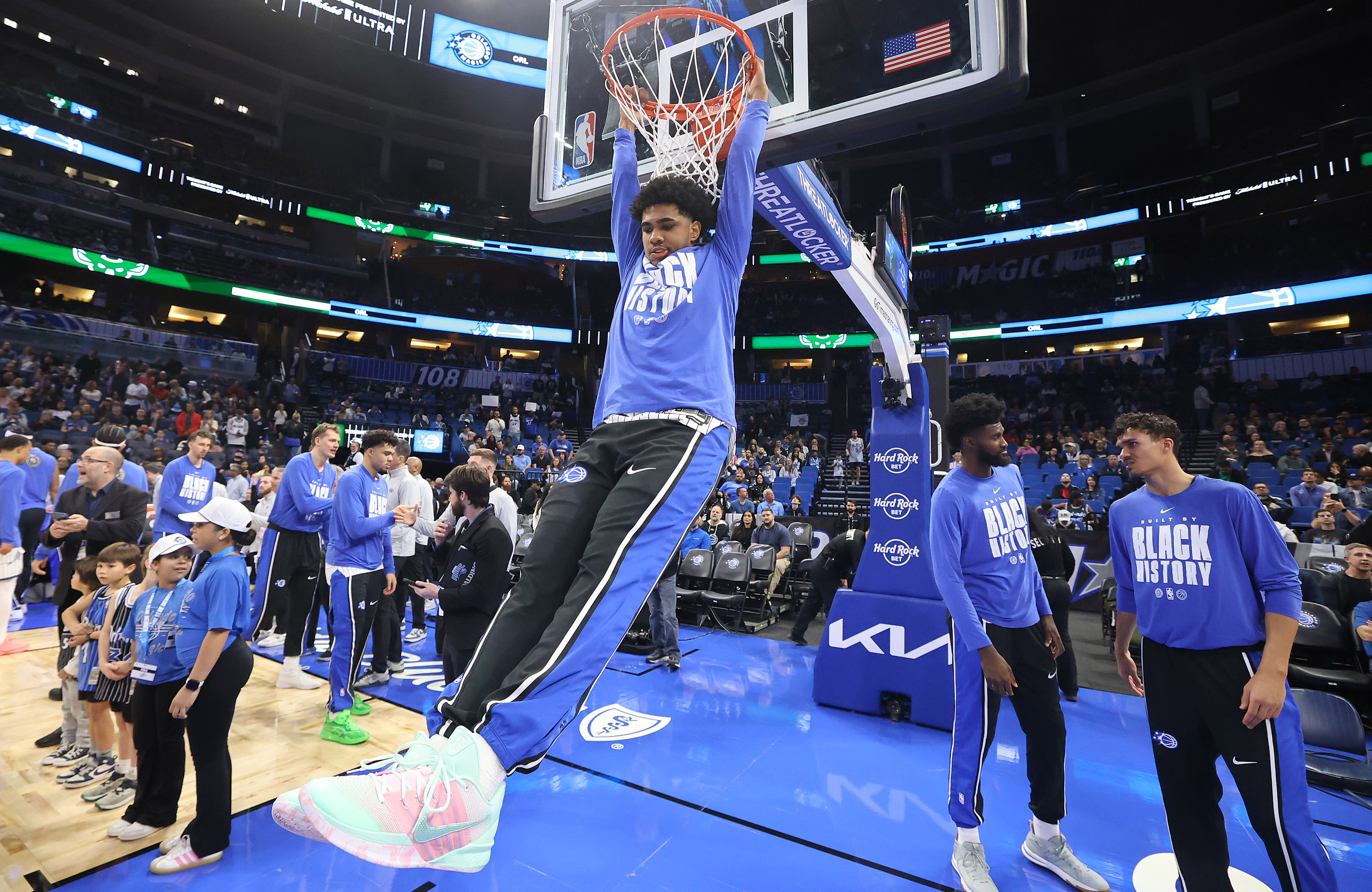 Orlando guard Jase Richardson hangs from the rim to warm...