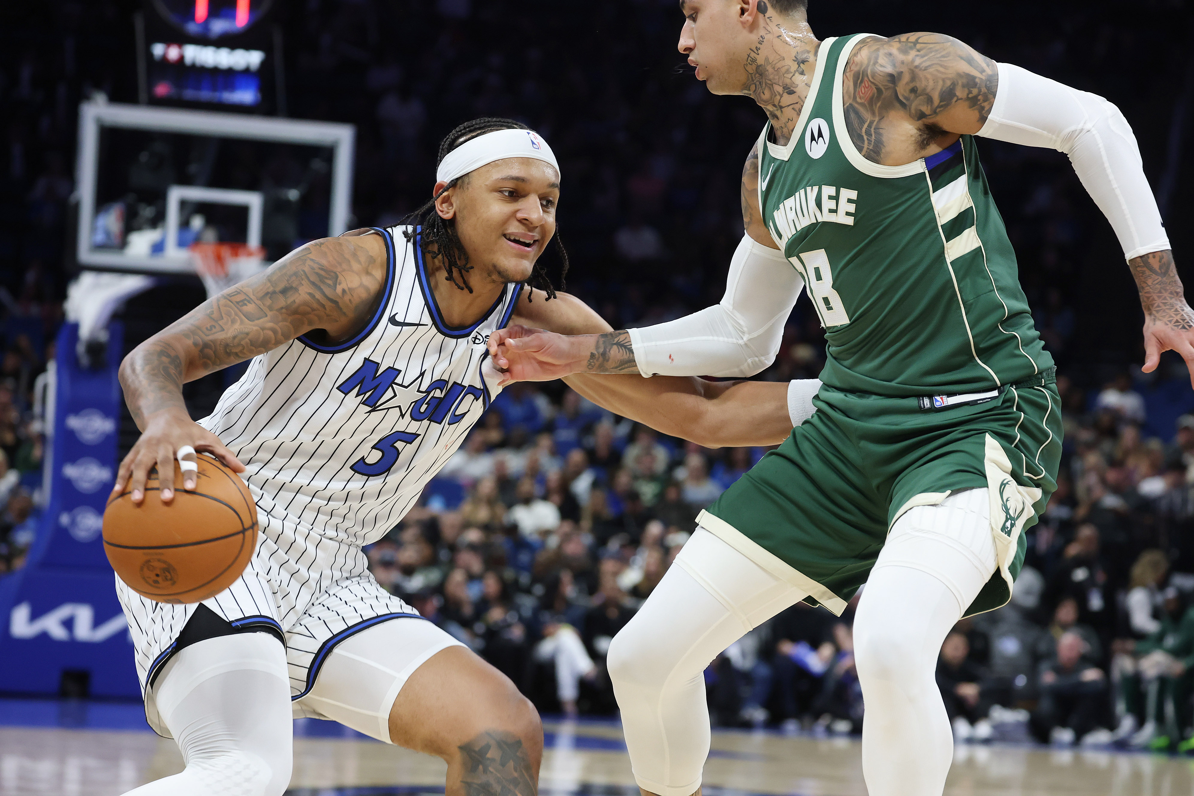 Orlando forward Paolo Banchero (5) tries to get past Milwaukee...