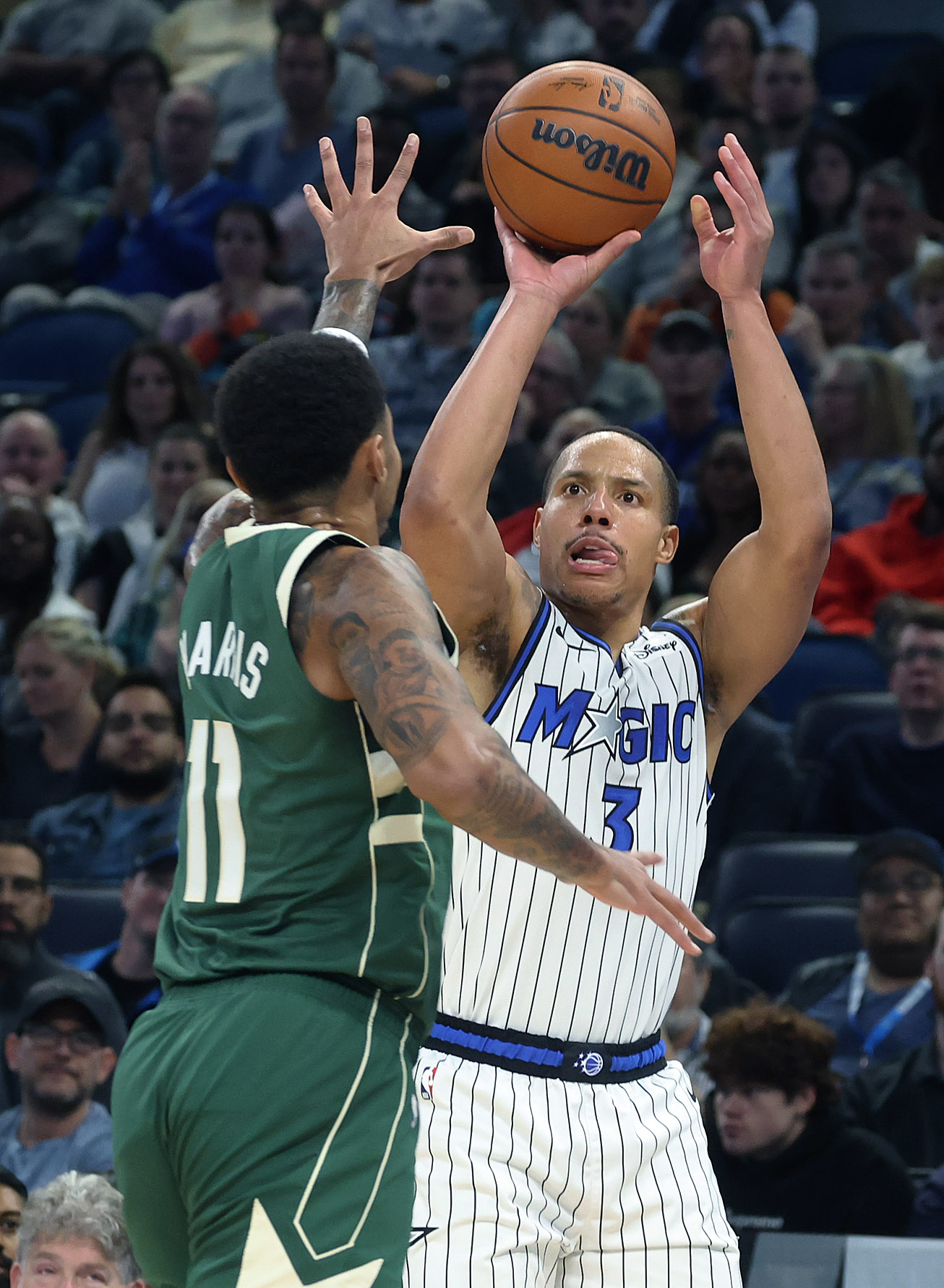 Orlando forward Desmond Bane (3) shoots beside Milwaukee guard Gary...