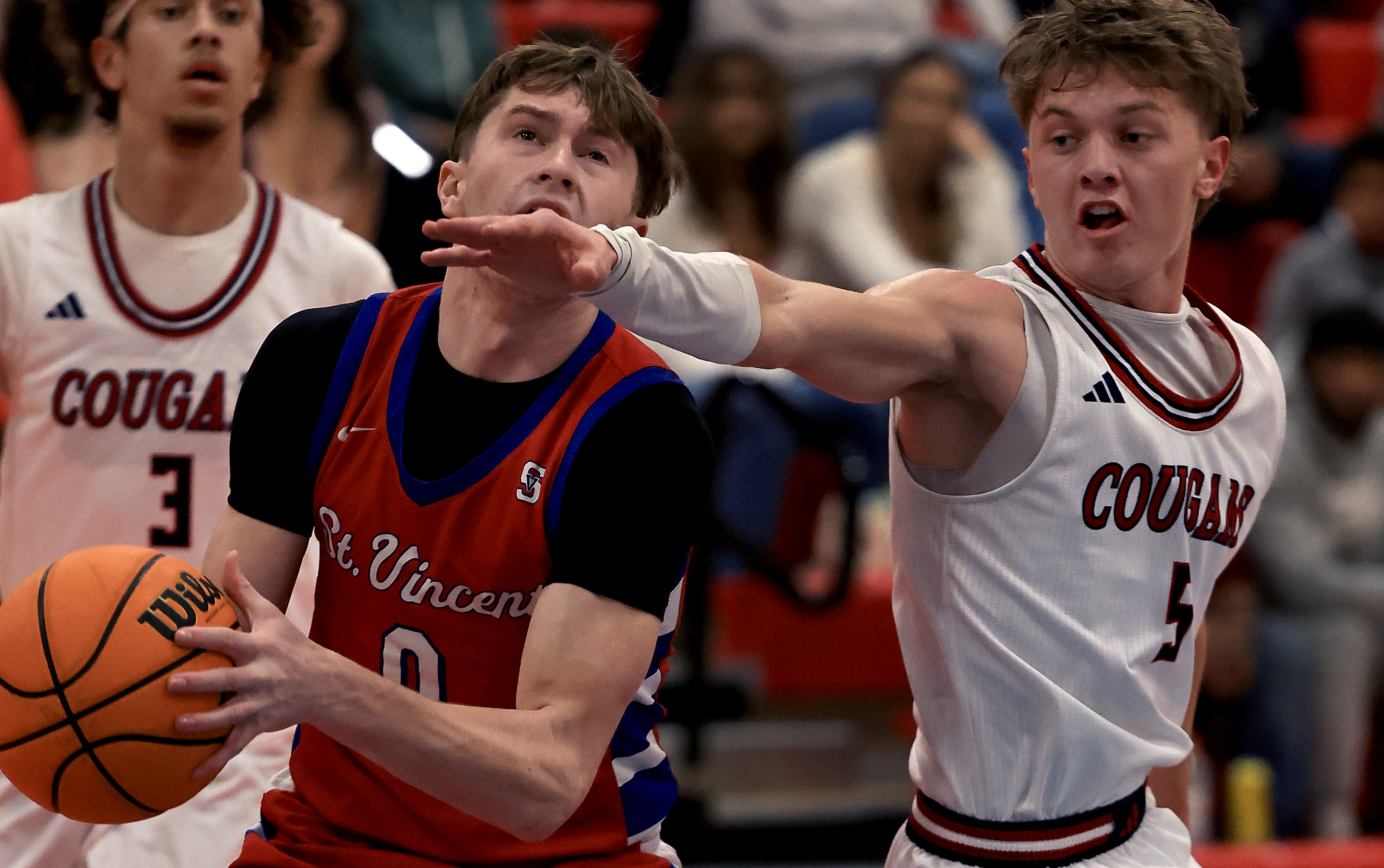 George Chaput of St. Vincent drives to the basket, guarded...