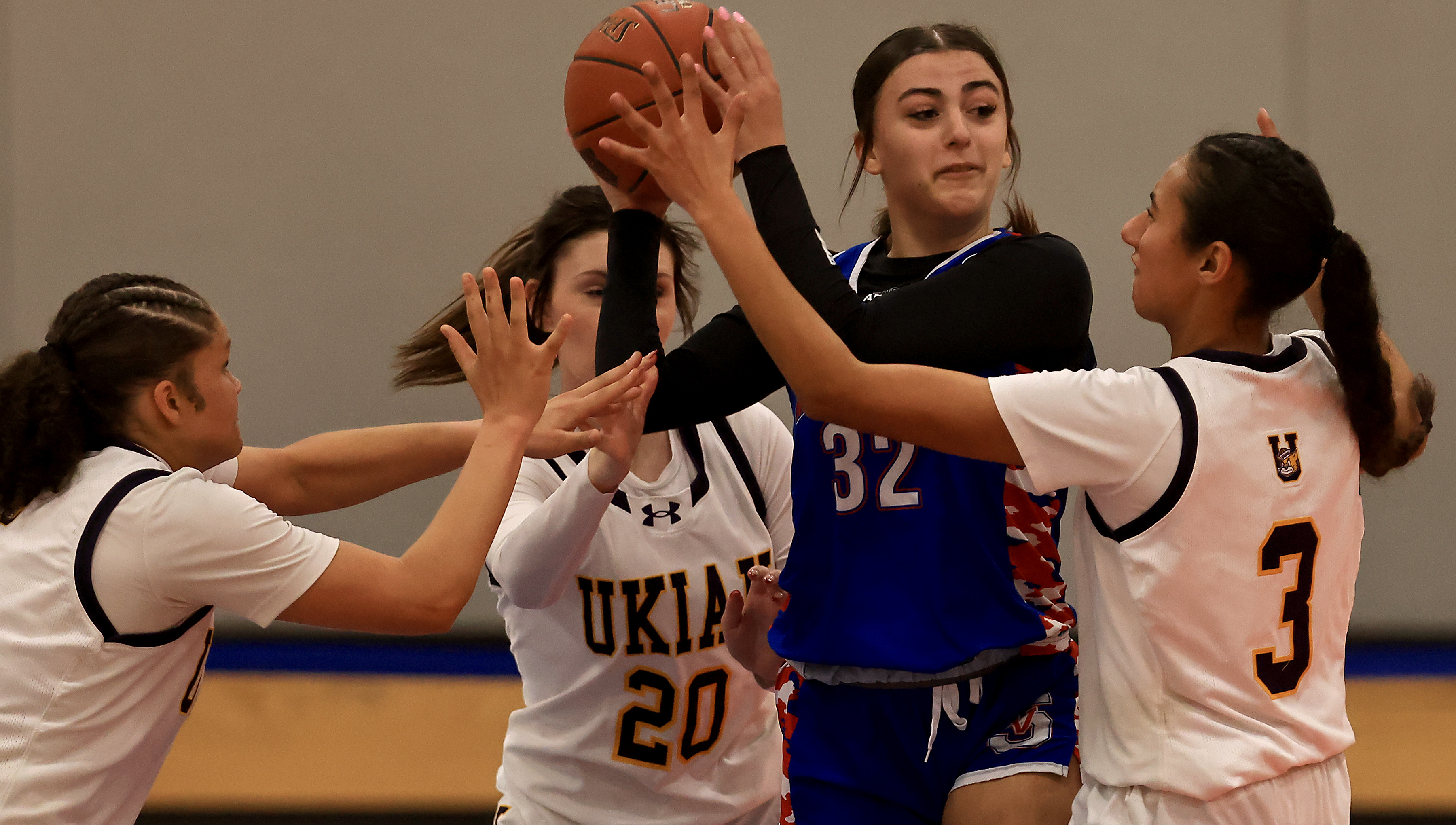 Ukiah defenders, from left, Aaliyah Wilson, Maya Wollitz, and Dana...