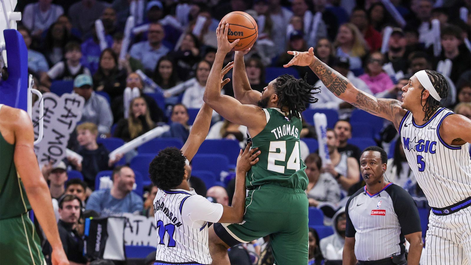 Milwaukee Bucks guard Cam Thomas (24) is fouled by Orlando Magic guard Jase Richardson (11) during the second half at Kia Center.