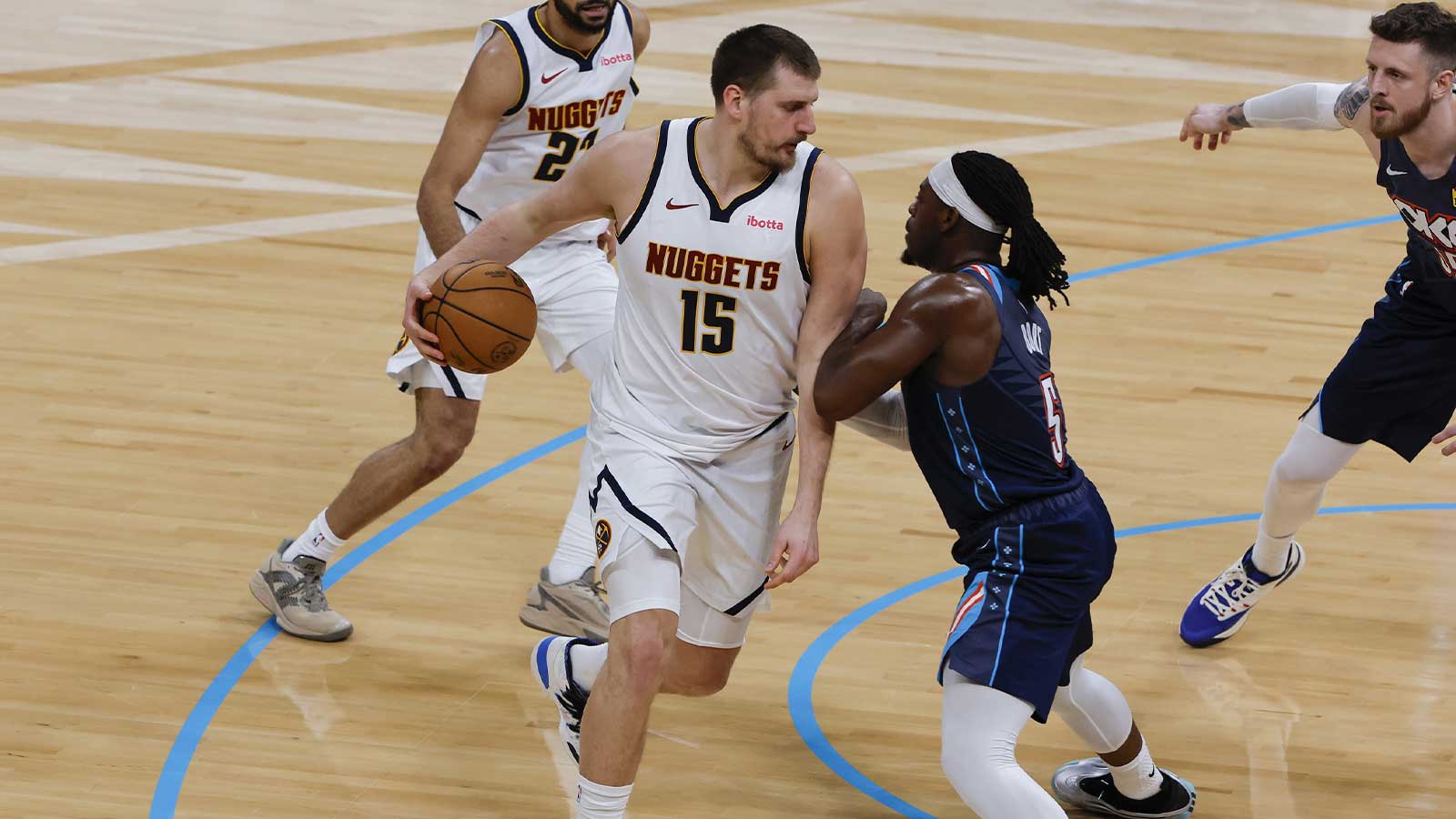 Nuggets center Nikola Jokić (15) drives against Oklahoma City Thunder guard Luguentz Dort (5) during the second quarter at Paycom Center