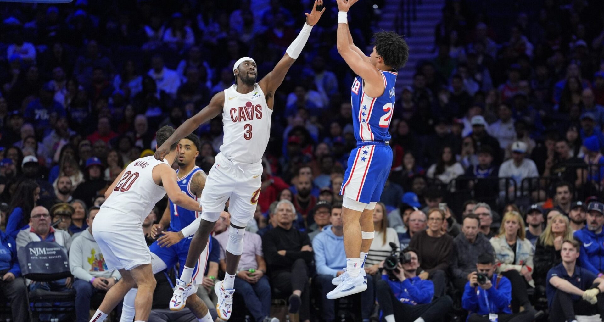 Nov 13, 2024; Philadelphia, Pennsylvania, USA; Philadelphia 76ers guard Jared McCain (20) shoots the ball against Cleveland Cavaliers guard Caris LeVert (3) in the third quarter at Wells Fargo Center.