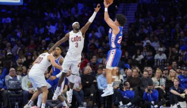 Nov 13, 2024; Philadelphia, Pennsylvania, USA; Philadelphia 76ers guard Jared McCain (20) shoots the ball against Cleveland Cavaliers guard Caris LeVert (3) in the third quarter at Wells Fargo Center.