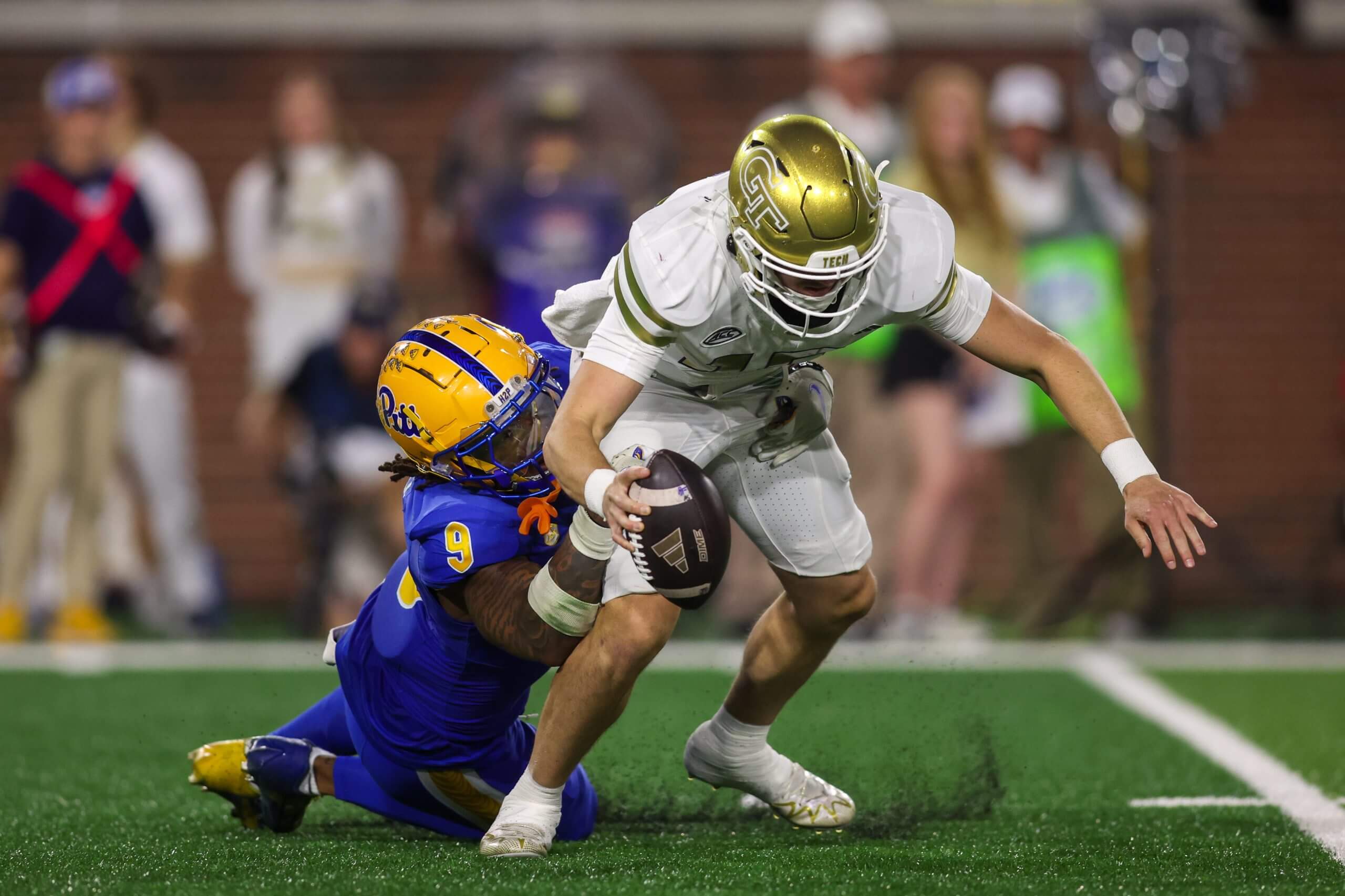 Georgia Tech Yellow Jackets quarterback Haynes King (10) is sacked by Pittsburgh Panthers linebacker Kyle Louis (9) in the first quarter at Bobby Dodd Stadium at Hyundai Field.