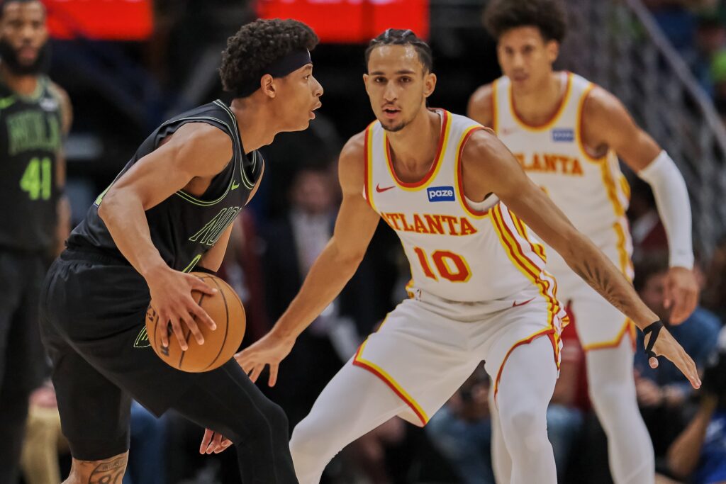 New Orleans Pelicans guard Jeremiah Fears (0) looks to pass against Atlanta Hawks forward Zaccharie Risacher (10) during the first half of the game at the Smoothie King Center.