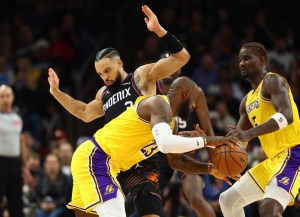 Dec 23, 2025; Phoenix, Arizona, USA; Los Angeles Lakers forward LeBron James (23) moves the ball against Phoenix Suns forward Dillon Brooks in the first half at Mortgage Matchup Center. Mandatory Credit: Mark J. Rebilas-Imagn Images