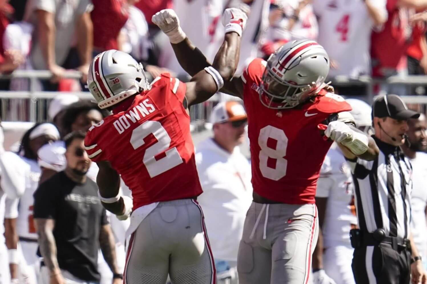 Ohio State defenders Caleb Downs and Arvell Reese lock arms in celebration during a game against Texas.