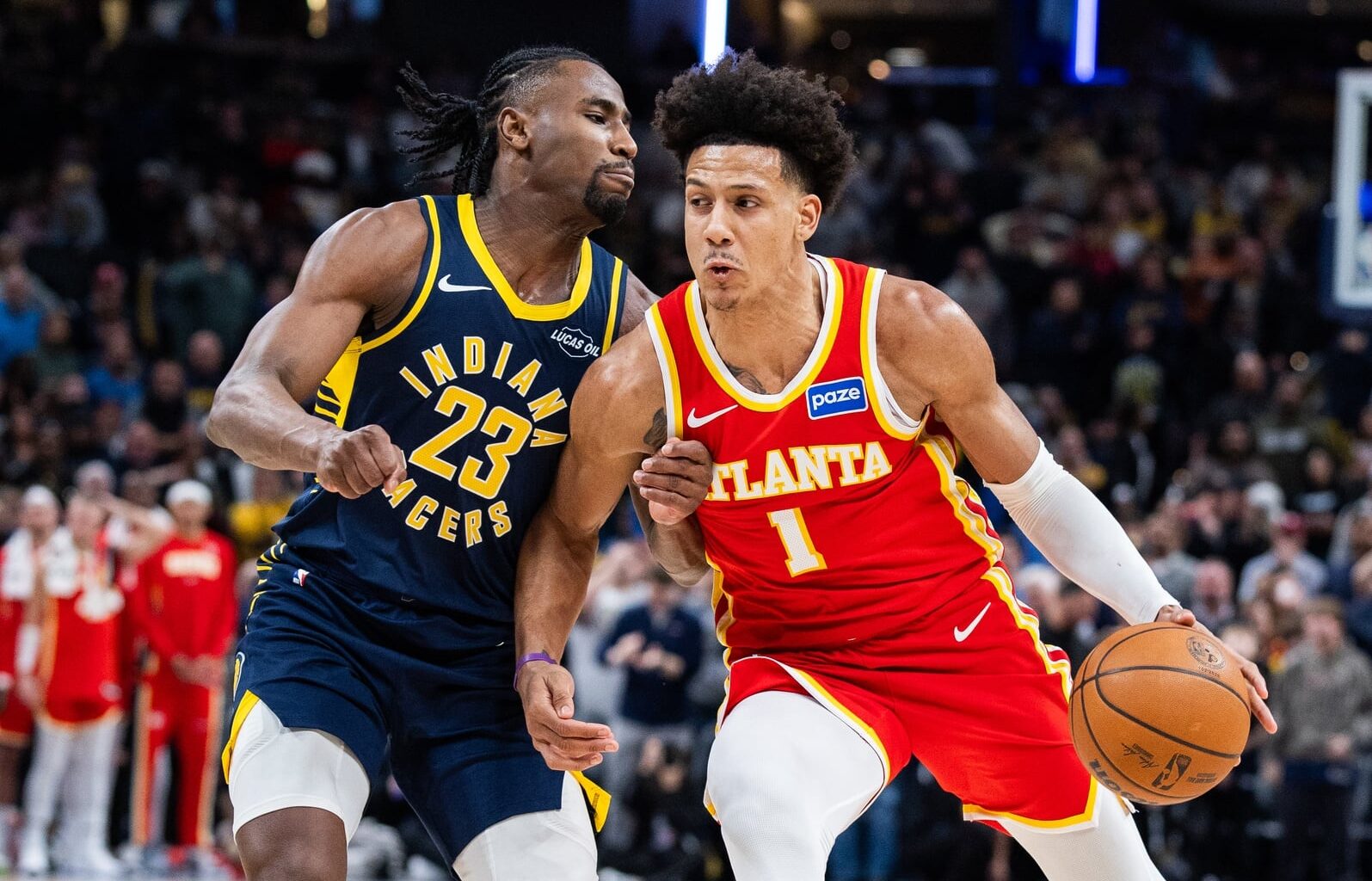 Jan 31, 2026; Indianapolis, Indiana, USA; Atlanta Hawks forward Jalen Johnson (1) dribbles the ball while Indiana Pacers guard/forward Aaron Nesmith (23) defends in the second half at Gainbridge Fieldhouse. Mandatory Credit: Trevor Ruszkowski-Imagn Images