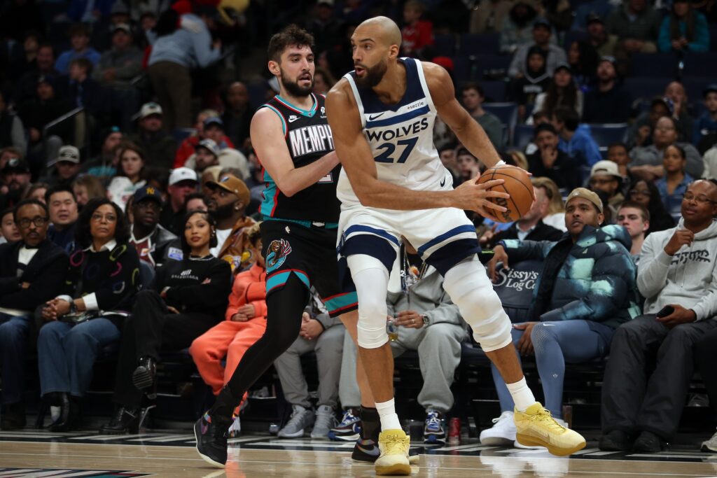 Jan 31, 2026; Memphis, Tennessee, USA; Minnesota Timberwolves center Rudy Gobert (27) handles the ball as Memphis Grizzlies guard Ty Jerome (2) defends during the fourth quarter at FedExForum. Mandatory Credit: Petre Thomas-Imagn Images