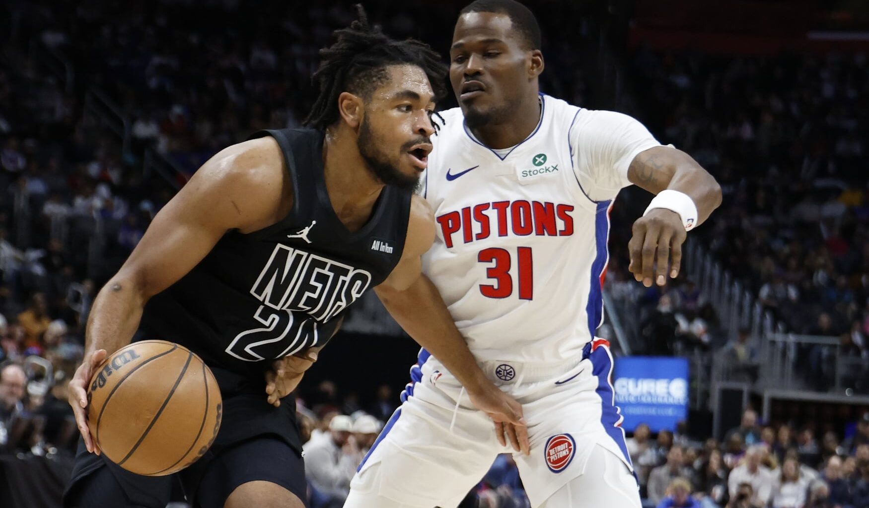 Brooklyn Nets guard Cam Thomas (24) dribbles on Detroit Pistons guard Javonte Green (31) in the first half at Little Caesars Arena.