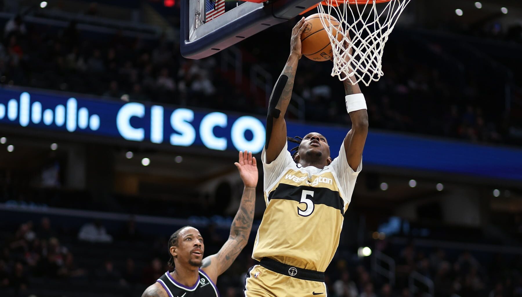 Feb 1, 2026; Washington, District of Columbia, USA; Washington Wizards guard Jamir Watkins (5) dunks over Sacramento Kings guard DeMar DeRozan (10) during the first half at Capital One Arena. Mandatory Credit: Daniel Kucin Jr.-Imagn Images