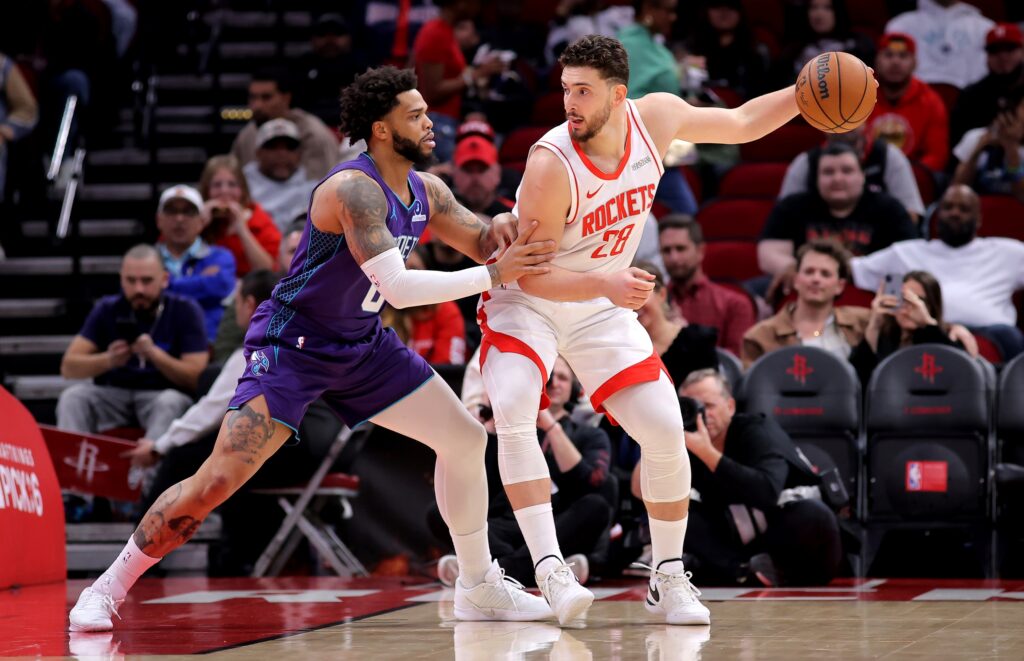  Houston Rockets center Alperen Sengun (28) dribbles against Charlotte Hornets forward Miles Bridges (0) during the first quarter at Toyota Center.