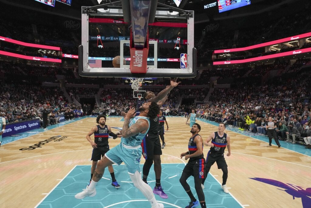 Feb 9, 2026; Charlotte, North Carolina, USA; Charlotte Hornets forward Miles Bridges (0) and Detroit Pistons center Jalen Duren (0) collide at the rim during the second half at Spectrum Center. Mandatory Credit: Jim Dedmon-Imagn Images