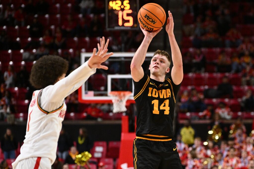  Iowa Hawkeyes guard Bennett Stirtz (#14) shoots for three points in the first half against the Maryland Terrapins at Xfinity Center.
