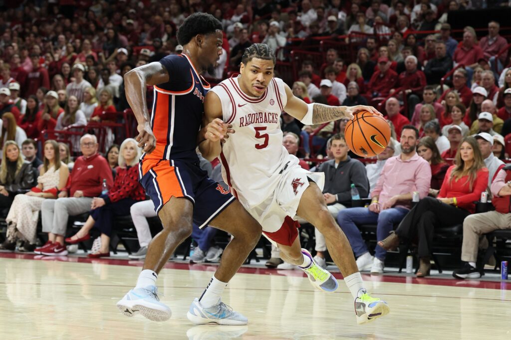  Arkansas Razorbacks guard Darius Acuff Jr (5) drives against an Auburn Tigers defender during the first half at Bud Walton Arena.