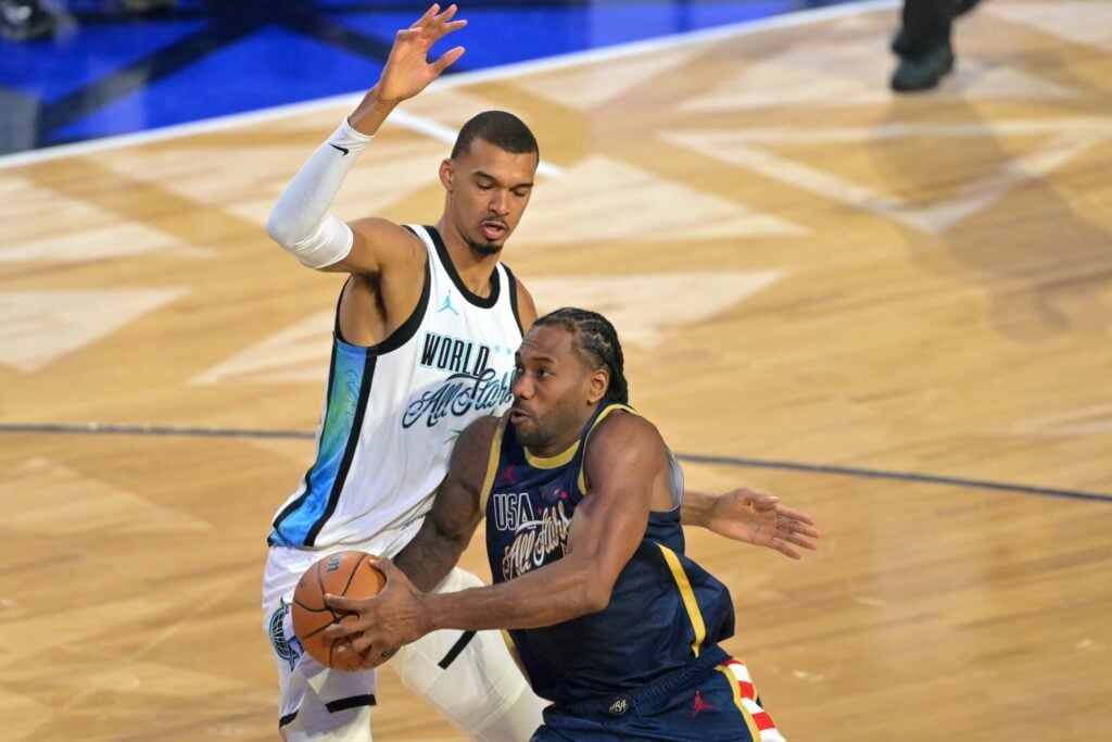 Feb 15, 2026; Inglewood, California, USA; Team USA Stripes forward Kawhi Leonard (2) of the LA Clippers controls the ball against Team World center Victor Wembanyama (1) of the San Antonio Spurs in game three during the 75th NBA All Star Game at Intuit Dome. Mandatory Credit: Jayne Kamin-Oncea-Imagn Images