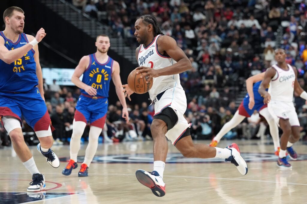 LA Clippers forward Kawhi Leonard (2) dribbles the ball against Denver Nuggets center Nikola Jokic (15) in the second half at Intuit Dome.