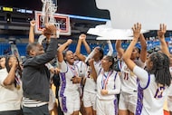 The Lincoln basketball team celebrates after beating Cuero in the Class 4A Division II state...
