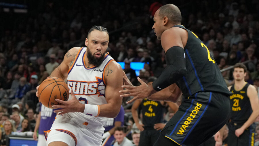 Phoenix Suns forward Dillon Brooks drives on Golden State Warriors center Al Horford (20) during th...