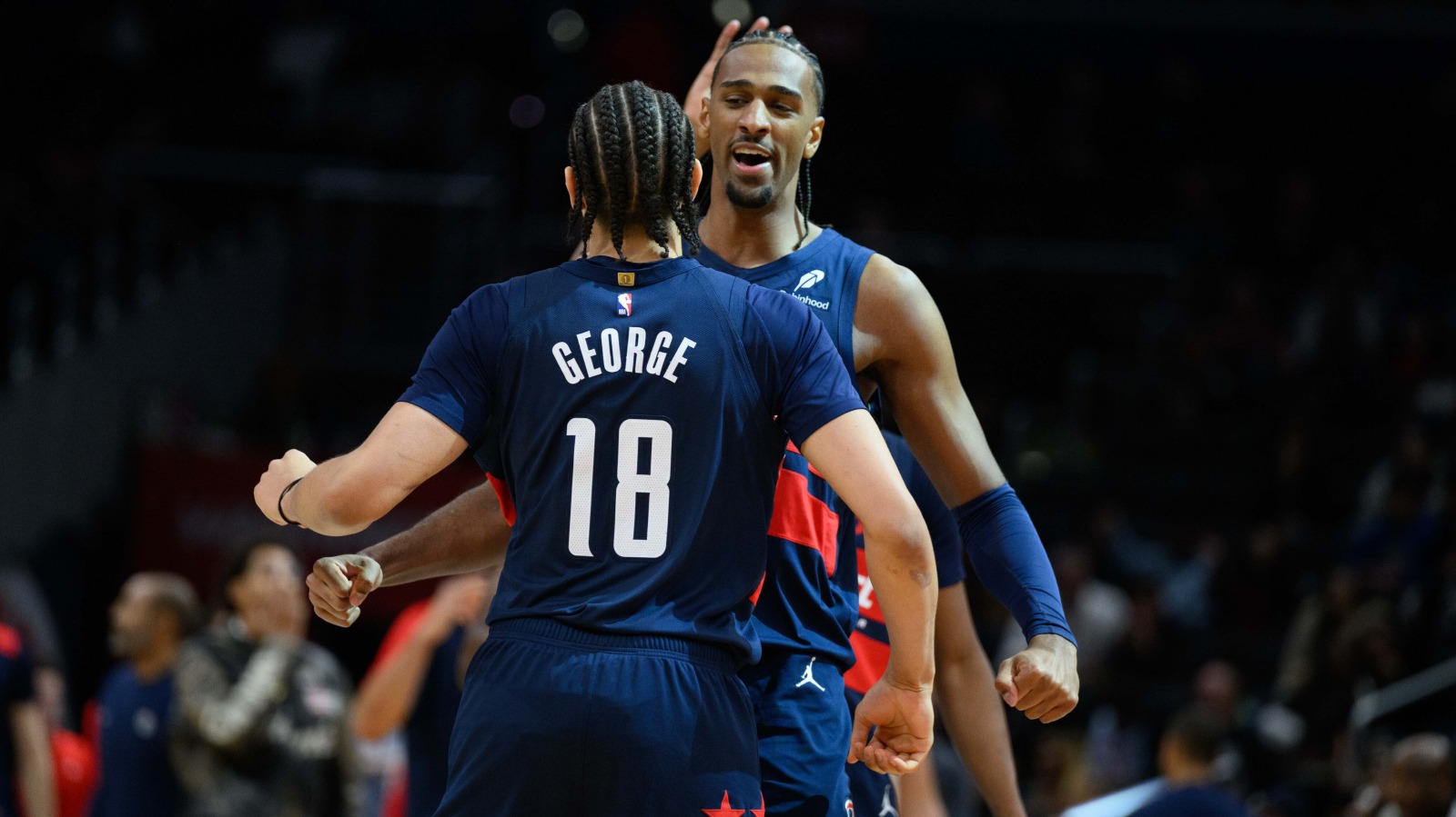Wizards forward Alex Sarr (20) celebrates with forward Kyshawn George (18) during the fourth quarter against the Utah Jazz at Capital One Arena