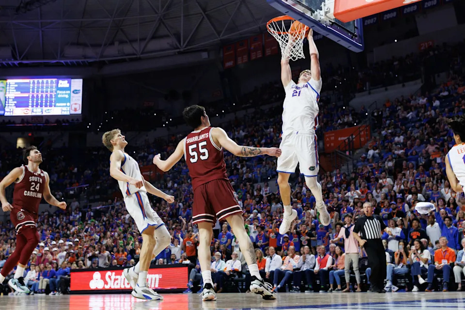 Feb 17, 2026; Gainesville, Florida, USA; Florida Gators forward Alex Condon (21) dunks the ball over South Carolina Gamecocks guard Mike Sharavjamts (55) during the second half at Exactech Arena at the Stephen C. O'Connell Center. Mandatory Credit: Matt Pendleton-Imagn Images