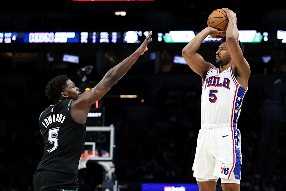Feb 22, 2026; Minneapolis, Minnesota, USA; Philadelphia 76ers guard Quentin Grimes (5) shoots over Minnesota Timberwolves guard Anthony Edwards (5) during the first half at Target Center. Mandatory Credit: Matt Krohn-Imagn Images