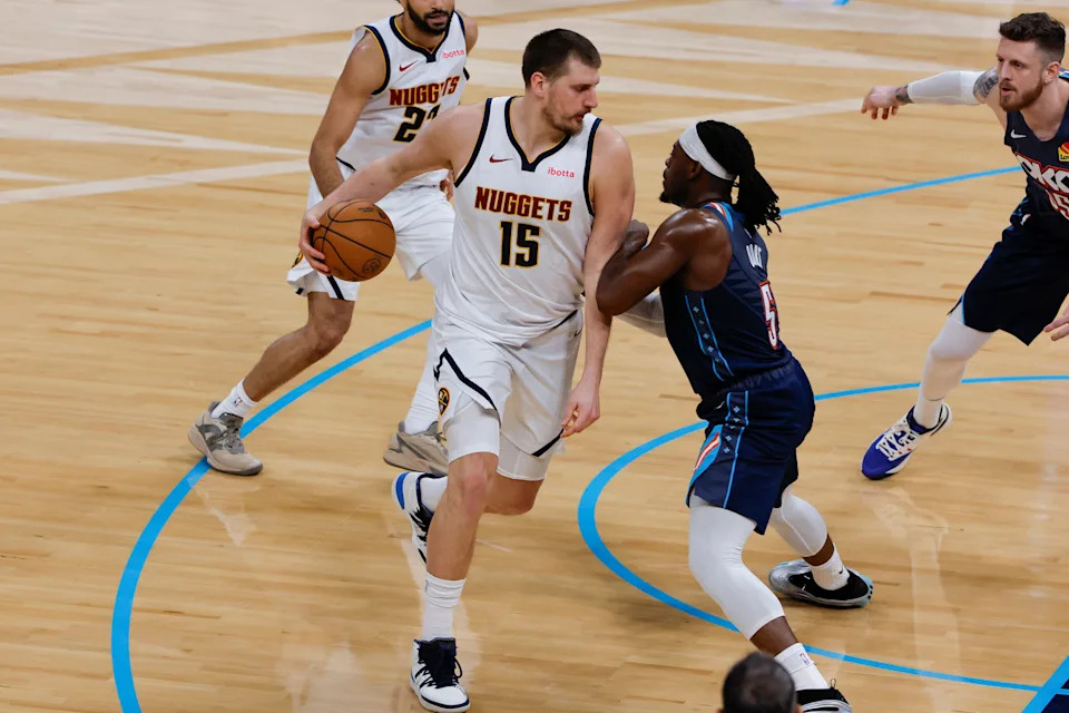 Feb 27, 2026; Oklahoma City, Oklahoma, USA; Denver Nuggets center Nikola Jokić (15) drives against Oklahoma City Thunder guard Luguentz Dort (5) during the second quarter at Paycom Center. Mandatory Credit: Alonzo Adams-Imagn Images