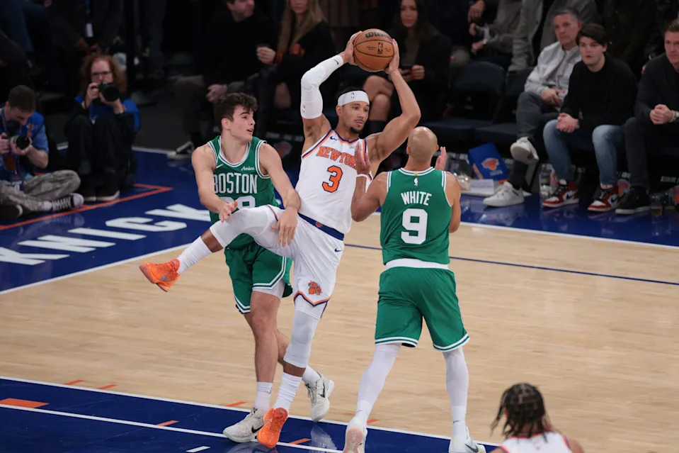 Oct 24, 2025; New York, New York, USA; New York Knicks guard Josh Hart (3) rebounds against Boston Celtics guard Hugo Gonzalez (28) and guard Derrick White (9) during the fourth quarter at Madison Square Garden. Mandatory Credit: Vincent Carchietta-Imagn Images