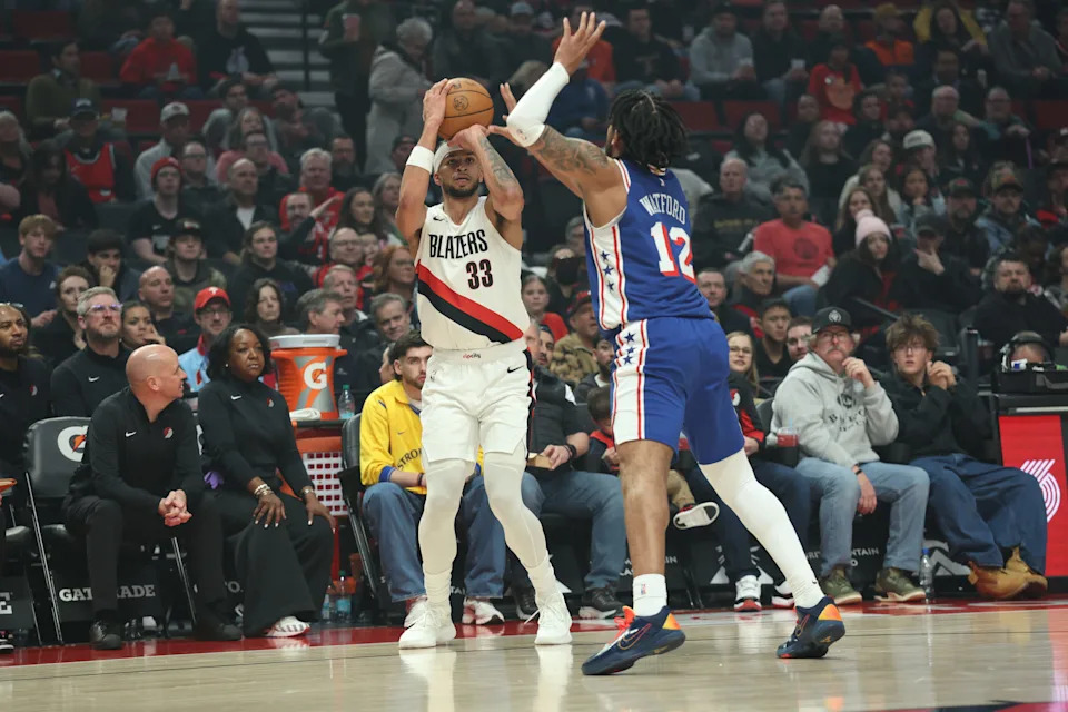 Feb 9, 2026; Portland, Oregon, USA; Portland Trail Blazers forward Toumani Camara (33) shoots the ball over Philadelphia 76ers guard/forward Trendon Watford (12) during the first half at Moda Center. Mandatory Credit: Jaime Valdez-Imagn Images