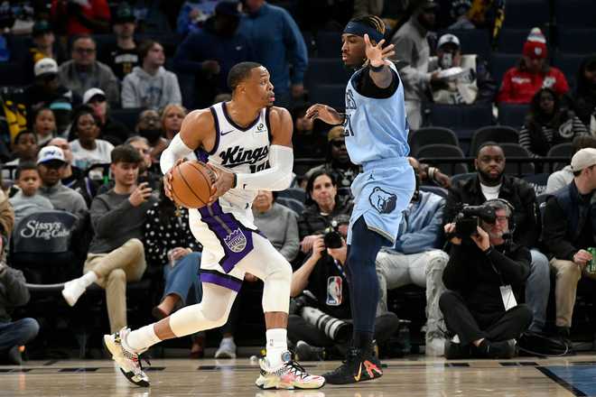Sacramento Kings guard Russell Westbrook, left, handles the ball against Memphis Grizzlies guard Jahmai Mashack, right, in the first half of an NBA basketball game Monday, Feb. 23, 2026, in Memphis, Tenn. (AP Photo/Brandon Dill)