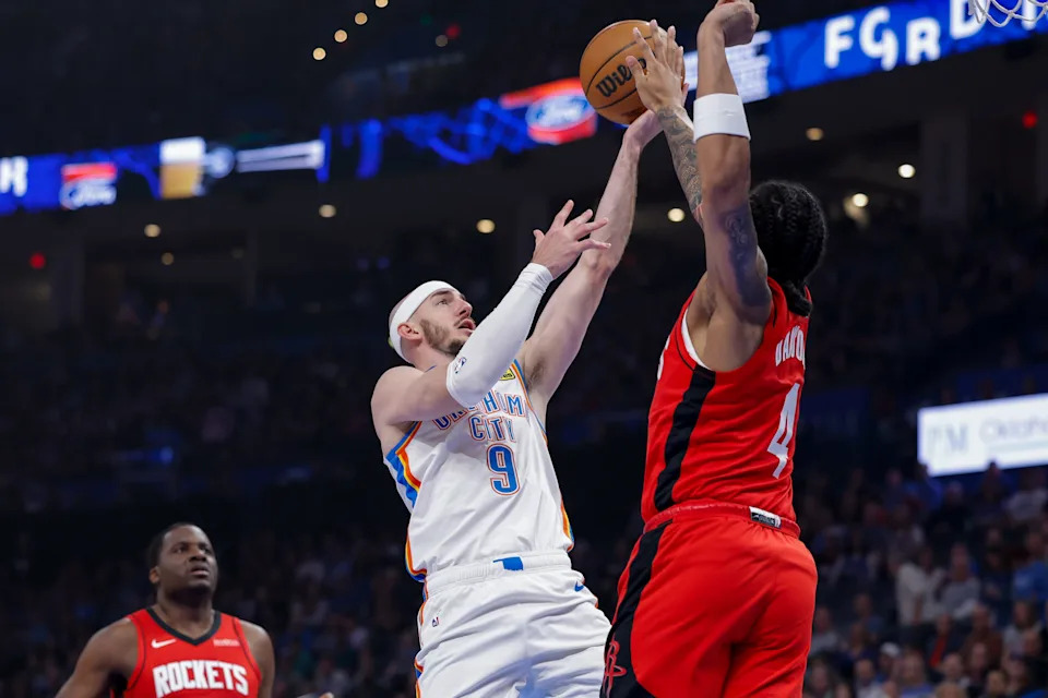 Feb 7, 2026; Oklahoma City, Oklahoma, USA; Oklahoma City Thunder guard Alex Caruso (9) shoots as Houston Rockets guard JD Davison (4) defends during the first half at Paycom Center. Mandatory Credit: Alonzo Adams-Imagn Images