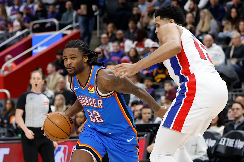 Feb 25, 2026; Detroit, Michigan, USA; Oklahoma City Thunder guard Cason Wallace (22) dribbles defended by Detroit Pistons forward Tobias Harris (12) in the second half at Little Caesars Arena. Mandatory Credit: Rick Osentoski-Imagn Images