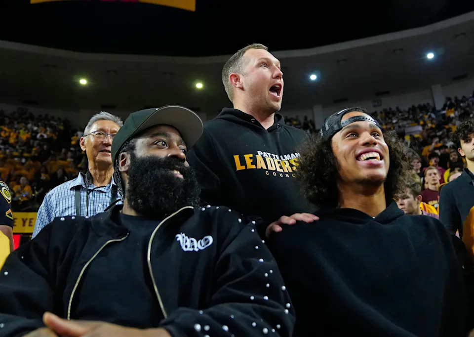 Arizona State football coach Kenny Dillingham, center, talks with former Arizona State basketball guard James Harden, left, and wide receiver Jordyn Tyson during a game Jan. 31, 2026, in Tempe, Arizona.