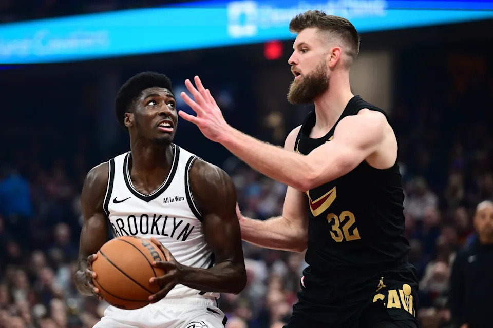 Brooklyn Nets guard Drake Powell (4) drives to the basket against Cleveland Cavaliers forward Dean Wade (32) on Feb. 19, 2026, in Cleveland.