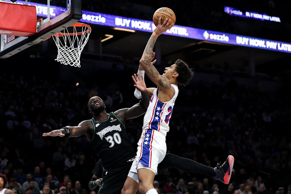 Feb 22, 2026; Minneapolis, Minnesota, USA; Philadelphia 76ers forward Dominick Barlow (25) shoots as Minnesota Timberwolves forward Julius Randle (30) defends during the first half at Target Center. Mandatory Credit: Matt Krohn-Imagn Images