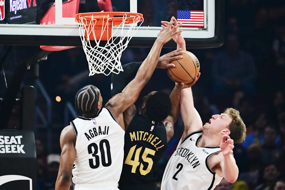 Feb 19, 2026; Cleveland, Ohio, USA; Cleveland Cavaliers guard Donovan Mitchell (45) drives to the basket between Brooklyn Nets guard Ochai Agbaji (30) and forward Danny Wolf (2) during the first half at Rocket Arena. Mandatory Credit: Ken Blaze-Imagn Images